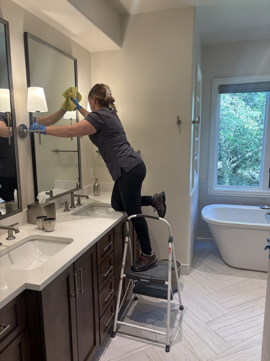 Professional housekeeping service in luxury bathroom